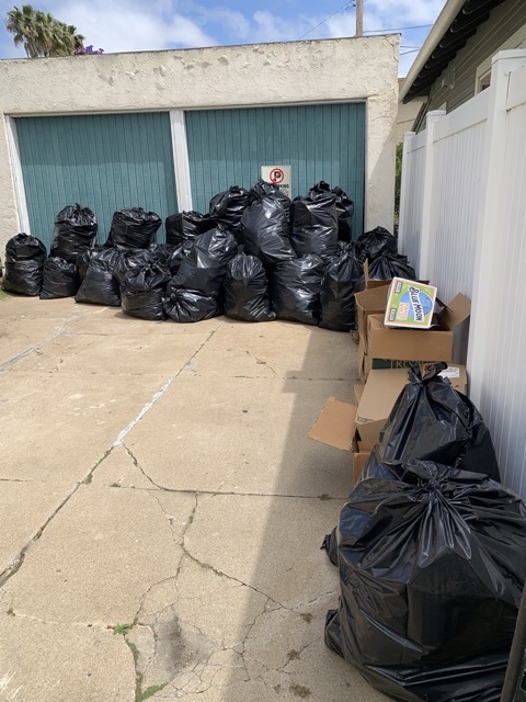 Trash bags and boxes filling a driveway