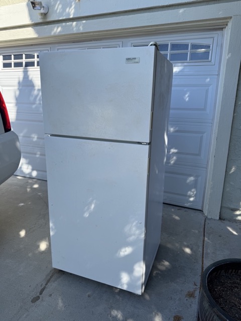 Refrigerator in a driveway for same day appliance removal