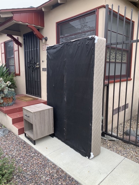 Mattress and nightstand on a San Diego porch
