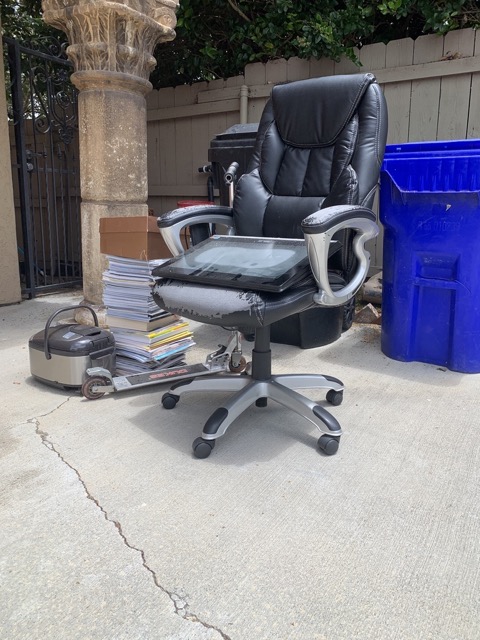 Office chair and small items staged for an office cleanout
