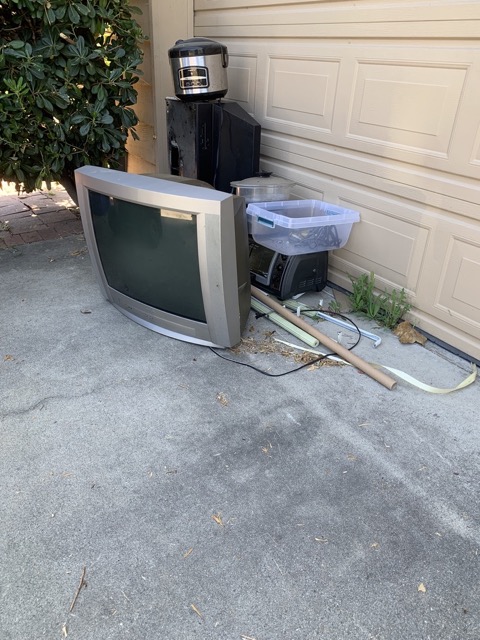 Old television and small appliances set out for e-waste pickup